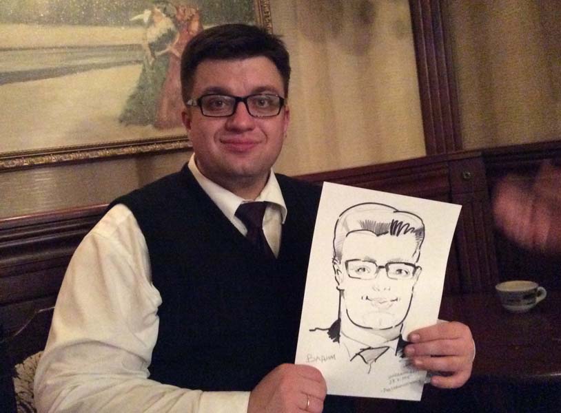 Вадим держит свой шарж на свадьбе